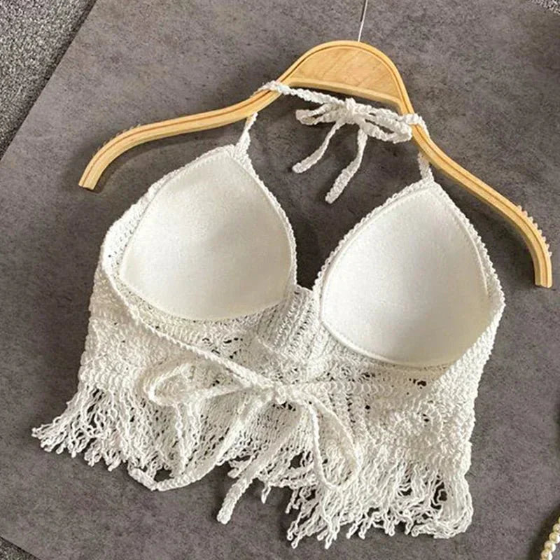 White crochet halter top with tassels, front view on hanger
