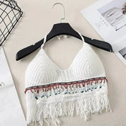 Cream crochet halter top with tassels and beaded trim, front view on hanger