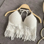 White crochet halter top with tassels, front view on hanger