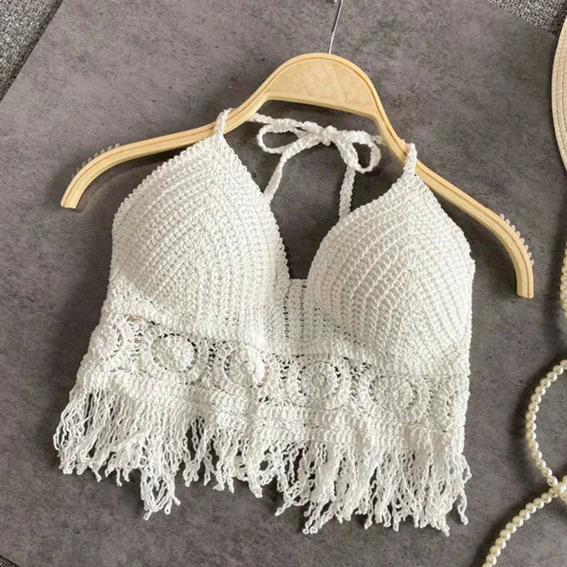White crochet halter top with tassels, front view on hanger