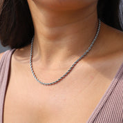 Silver twisted rope necklace worn on neck