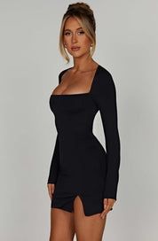Black mini dress with square neckline and front side slit, side view