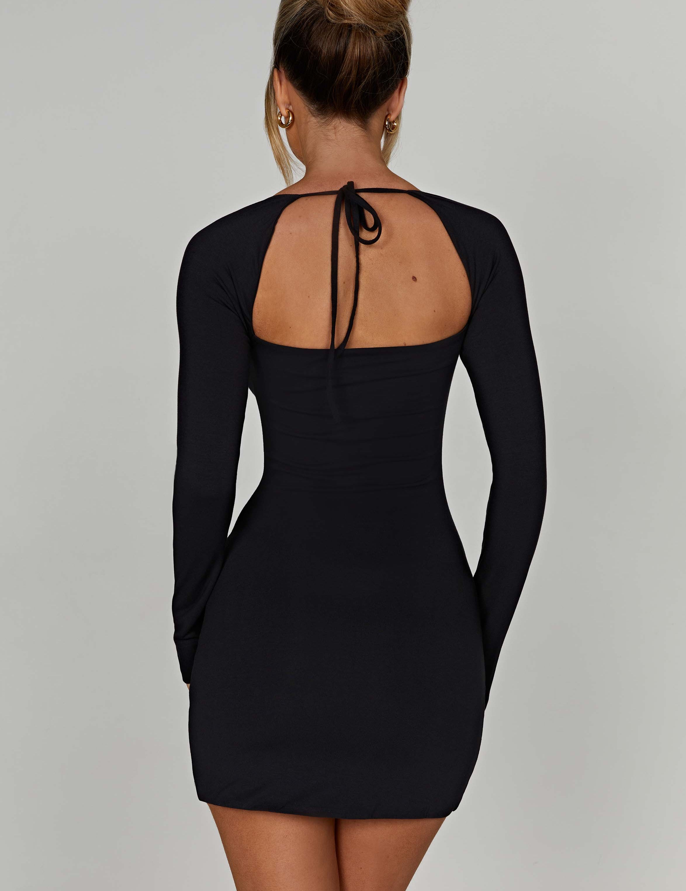 Black mini dress with square neckline and front side slit, back view