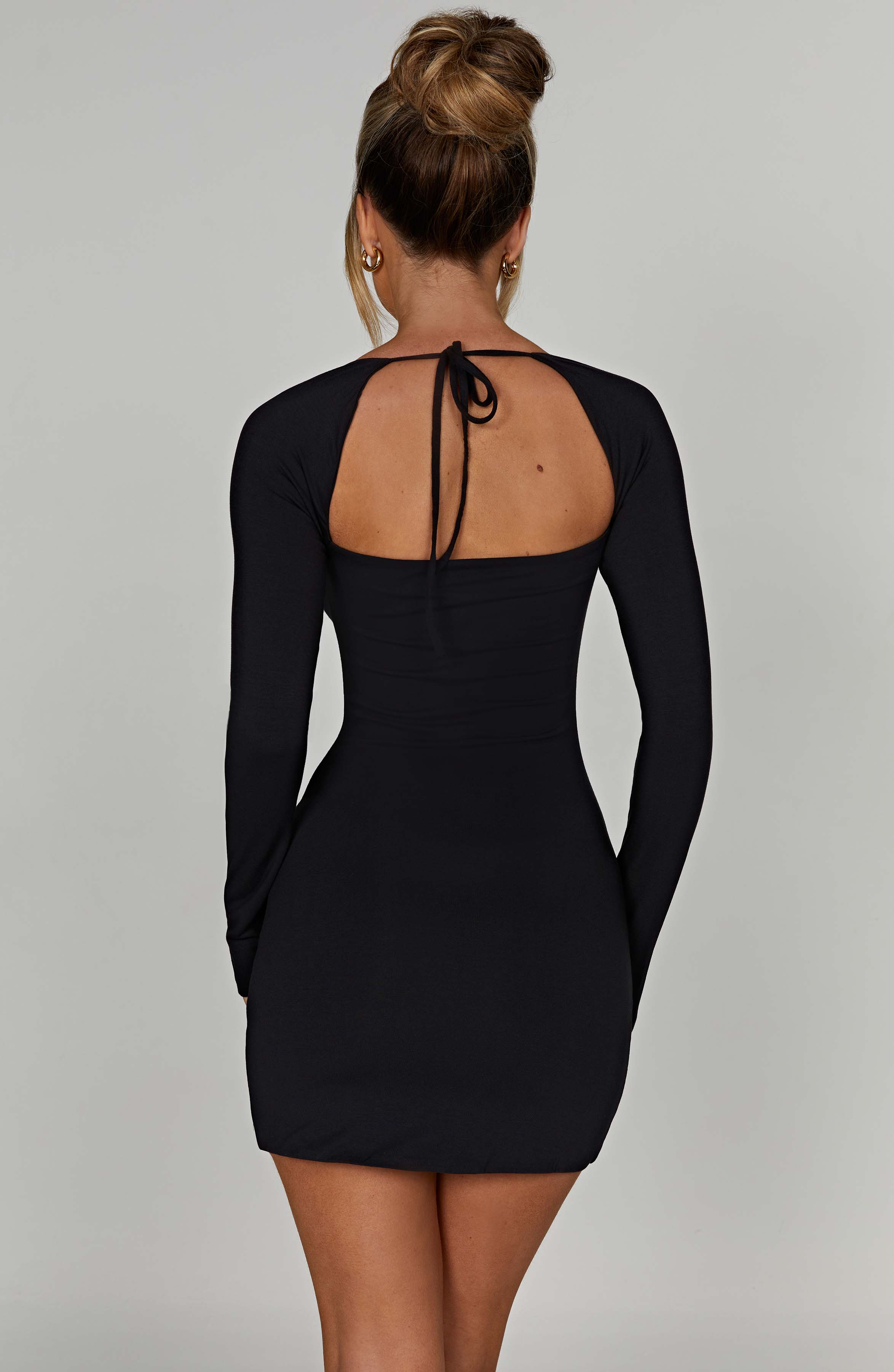 Black mini dress with square neckline and front side slit, back view