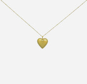 Gold heart pendant necklace on chain isolated on white background