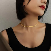 Gold herringbone necklace angled view on model