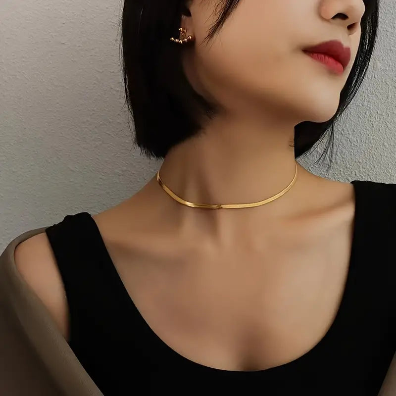 Gold herringbone necklace angled view on model