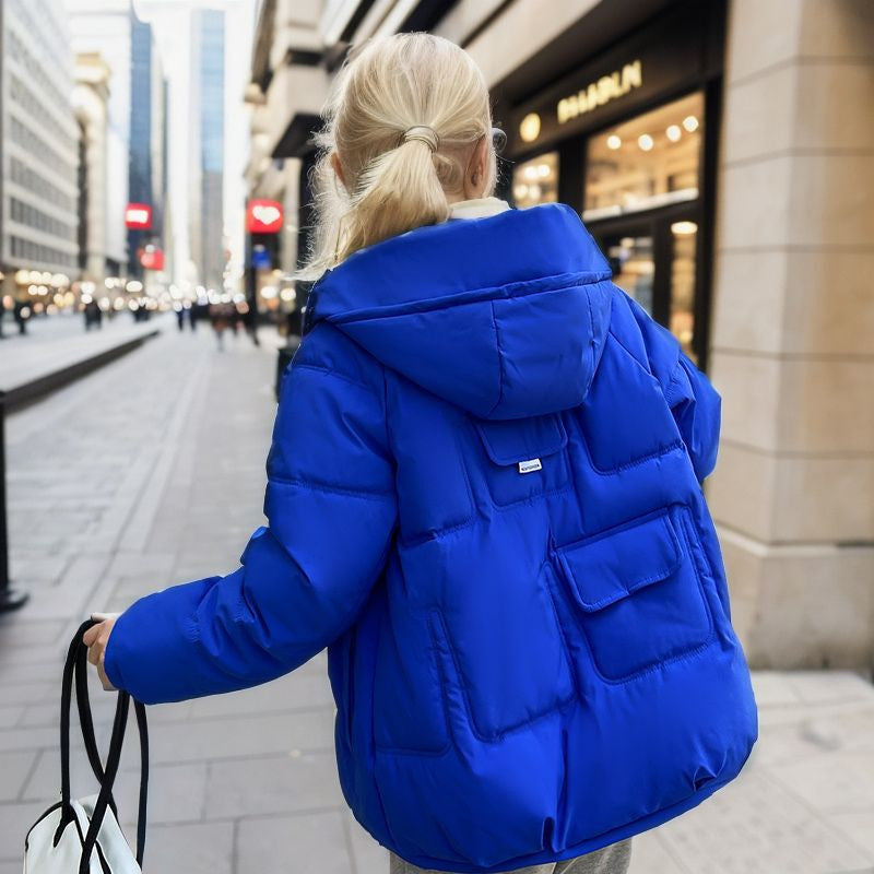 Puffer jacket blue with hood urban setting