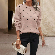 Pink knit sweater with black polka dots three-quarter view