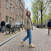 Person wearing beige suede sneakers with shearling lining outdoor setting