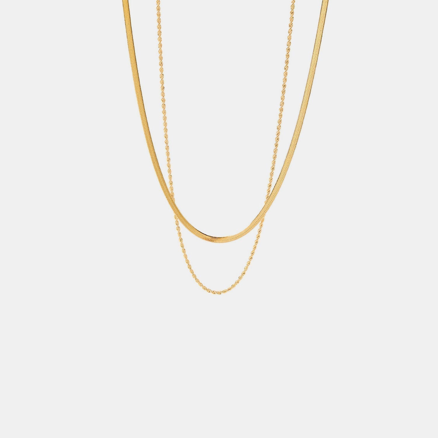 Gold-colored layered necklace against white background straight view