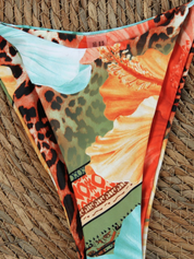 Bikini bottom with tropical floral and leopard print, flat lay