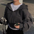Gray zip-up hoodie with hood worn side view