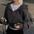 Gray zip-up hoodie with hood worn side view