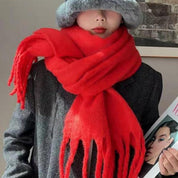 Red scarf with fringe wrapped around neck front view
