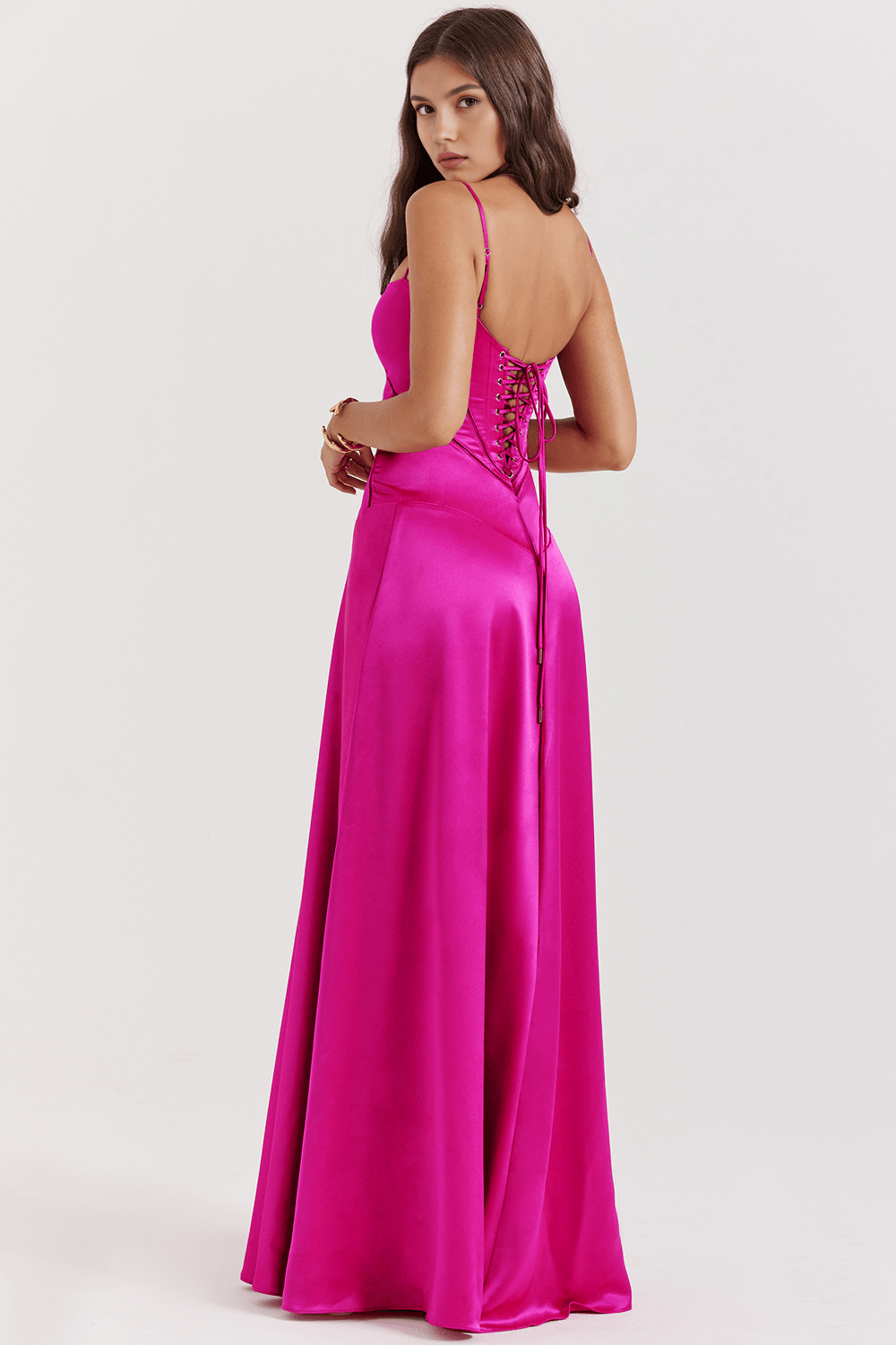 Fuchsia satin evening gown back view with hand on hip
