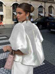 White silk blouse with puffed sleeves and matching pants close-up detail