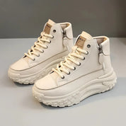 White high-top sneakers with platform sole angled view