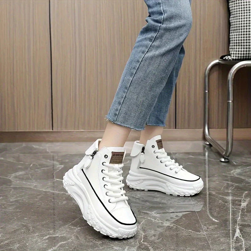 White high-top sneakers with platform sole worn with jeans