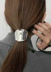Silver hair cuff with organic texture, worn on ponytail, close-up side view