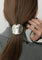 Silver hair cuff with organic texture, worn on ponytail, close-up side view