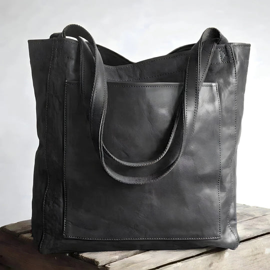 Black leather tote bag with exterior pocket front view