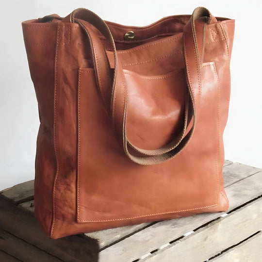 Brown leather tote bag with exterior pocket front view