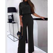 Black pantsuit set with crop top and wide legs, side view