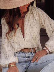 White lace blouse with floral pattern and tassel ties side view