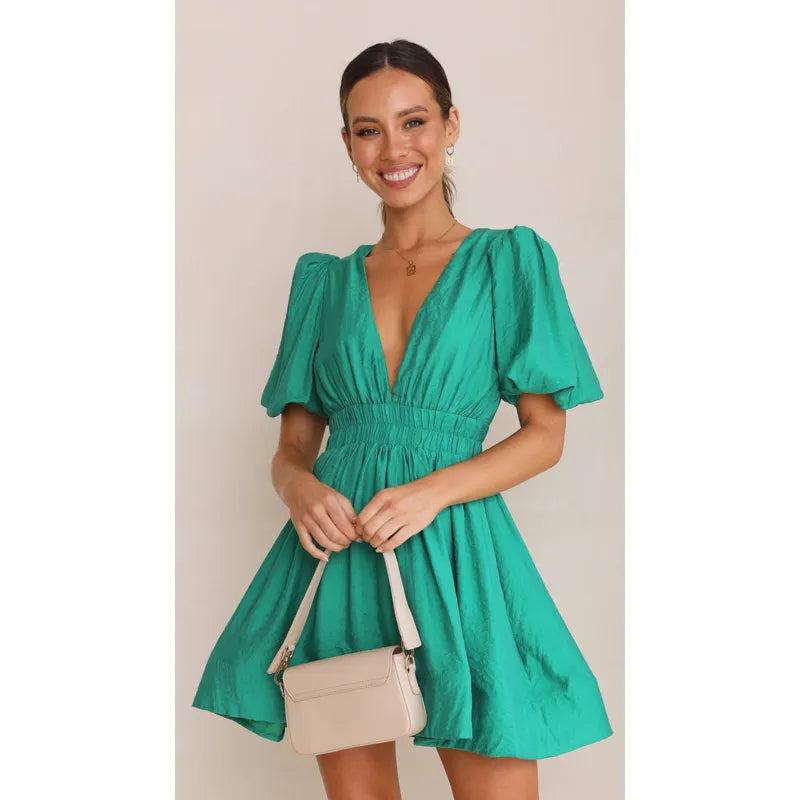 Green dress with deep V-neck and puffed sleeves side view