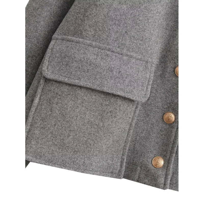 Gray jacket pocket detail with gold buttons