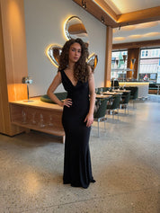 Evening dress black front view with hand on hip