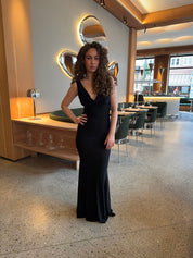 Evening dress black front view with hand on hip
