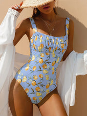 Blue swimsuit with lemon print and ruched detail front view