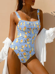 Blue swimsuit with lemon print and ruched detail front view with white cover-up