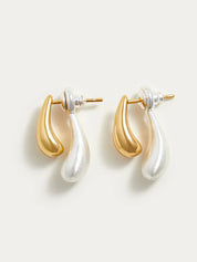 Gold and silver earrings teardrop design angled view
