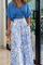 Blue crop top and white pants with bird print, side view