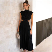 Black dress with cut-out details and pleated skirt side view