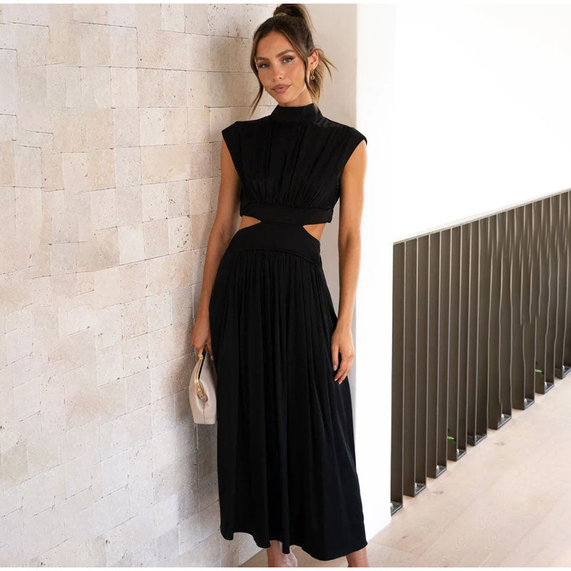 Black dress with cut-out details and pleated skirt side view