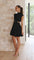Black dress with cut-out details and pleated skirt front view